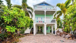A two-story building with a balcony and a covered walkway. - Waterfront Key West Oasis w/ Float Dock! (Key West)