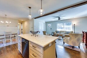 A spacious kitchen with a central island, wooden flooring, and pendant lighting. - 4 Mi to Beach: Wilmington Home w/ Gazebo Deck! (Wilmington)