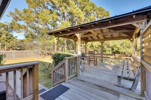 A wooden deck with a covered seating area, a wooden fence, and trees in the background. - 4 Mi to Beach: Wilmington Home w/ Gazebo Deck! (Wilmington)