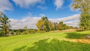 A grassy field with trees and a clear sky. - Charming Rockland Retreat w/ Deck & Grill! (Bangor)