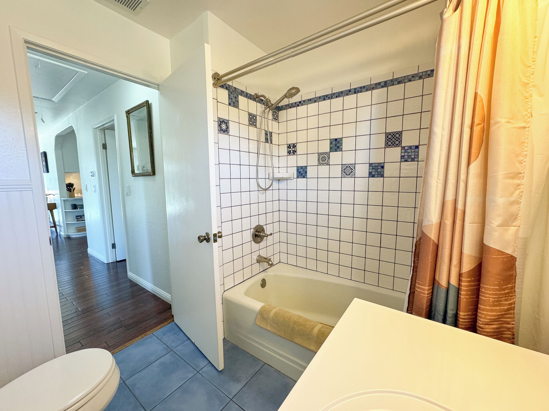A bathroom with a bathtub, a shower, and a toilet.