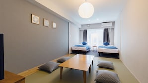 A modern hotel room with two beds, a wooden table, and tatami mats. - HOTEL ECCLESIA (Kyoto)