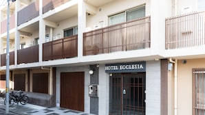 A hotel named 'Hotel Ecclesia' with a modern design, featuring a checkered floor pattern, a bike parking area, and a visible elevator. - HOTEL ECCLESIA (Kyoto)