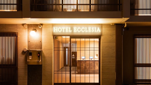 The exterior of Hotel Ecclesia with a reception desk, a phone, and a digital display. - HOTEL ECCLESIA (Kyoto)