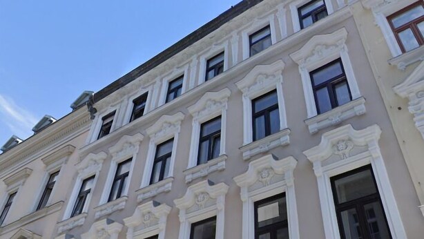 A multi-story building with classical architectural style, featuring ornate window frames and decorative moldings. - Luxury Apartment in the heart of Vienna  (Vienna)