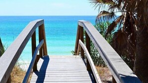 A wooden boardwalk leading to a beach with clear blue water and palm trees. - Playa Bonita on 30A - Gulf View / Pickleball / Deeded Beach Access (Santa Rosa Beach)
