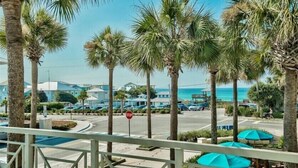 A coastal hotel with palm trees, a stop sign, and a view of the sea. - Playa Bonita on 30A - Gulf View / Pickleball / Deeded Beach Access (Santa Rosa Beach)