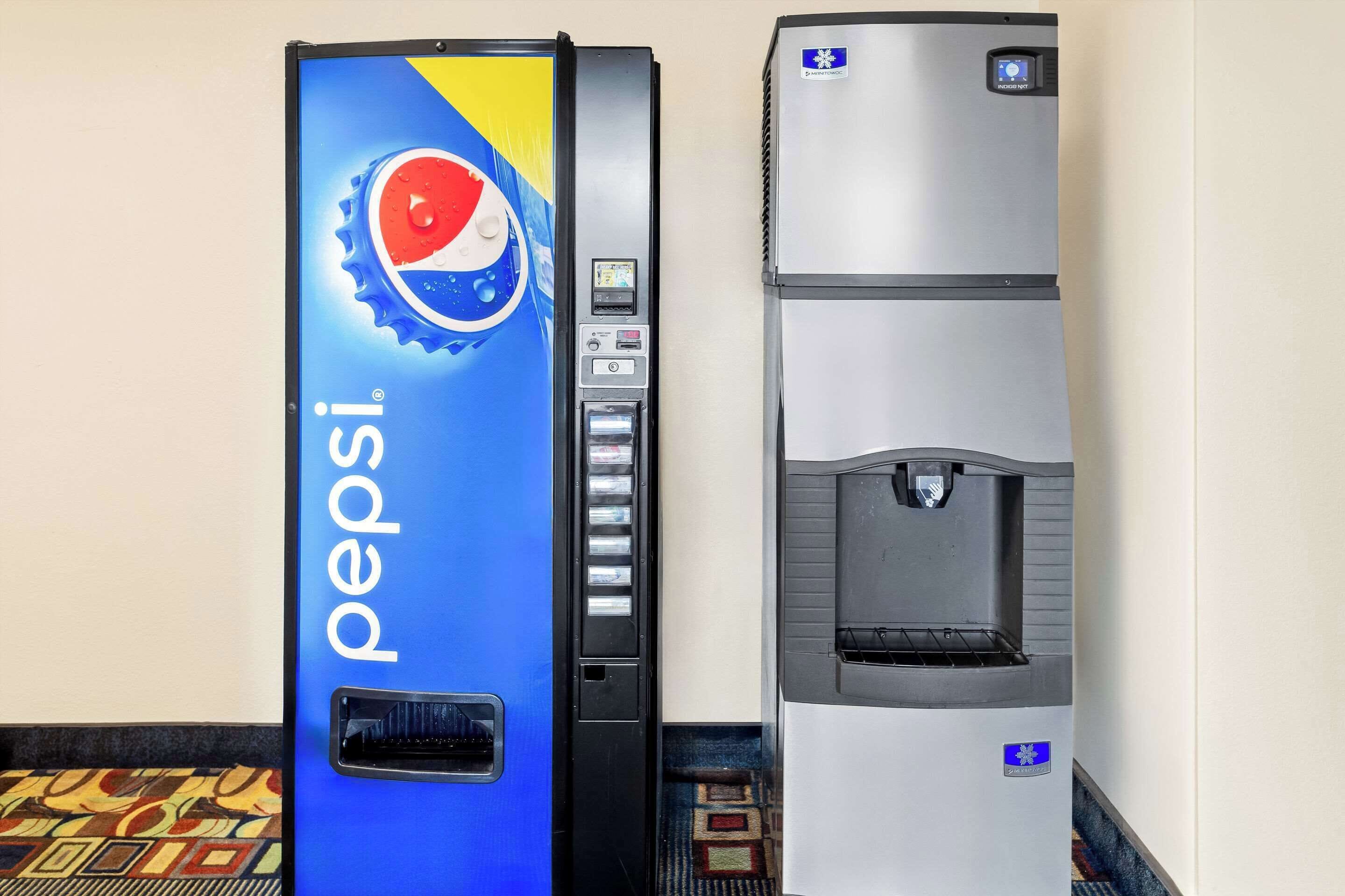Two beverage dispensers, one branded with Pepsi and the other with a generic design, both with digital displays and dispensing spouts.