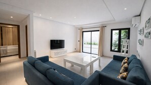 A modern living room with a sofa set, a coffee table, and a flat-screen TV. - Victor Hugo (La Marsa)