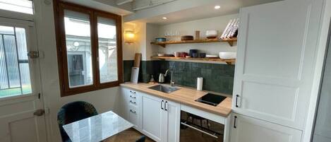 Fridge, oven, coffee/tea maker, cookware/dishes/utensils