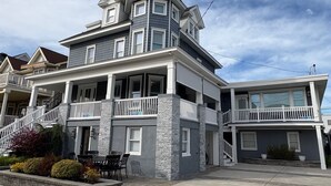 A two-story house with a balcony, a covered porch, and a garage.