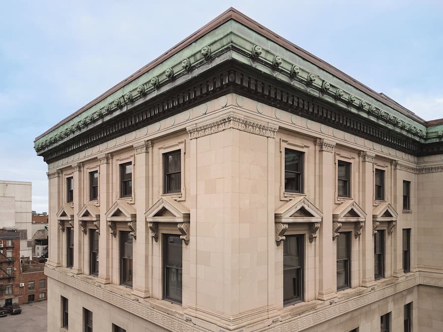 A building with a classical architectural style, featuring a symmetrical facade, large windows, and decorative moldings.