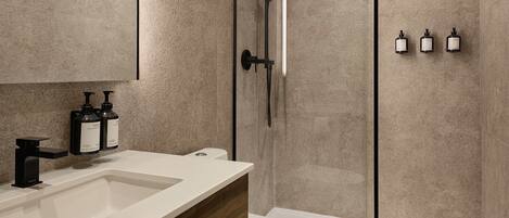 Un baño moderno con ducha, inodoro y lavamanos.