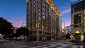 A multi-story building with a prominent corner entrance, large windows, and a flat roof. - Reside Craftsman Los Angeles, a Wyndham Residence (Los Angeles)