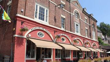 A red brick building with multiple storefronts, each with a sign reading "Ironbridge - The Square."