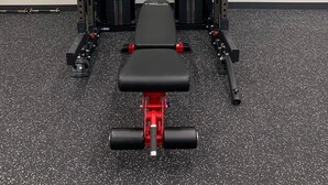 A gym with a bench press, squat rack, and various weight plates. - One bedroom within 2 minute walk to Main Village.
 (Beaverdell)