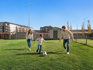 Children’s area - 1BR Walk Out Suite » Backyard » Patio » 65” TV (Calgary)