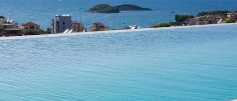 Seasonal outdoor pool, pool umbrellas, pool loungers