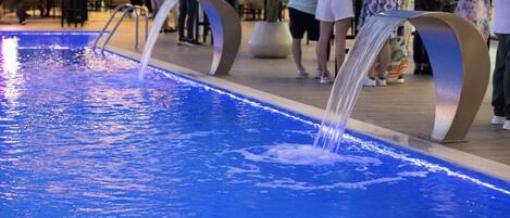 A pool with water jets and a modern design.