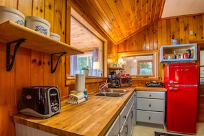 Fridge, coffee/tea maker, toaster, cookware/dishes/utensils