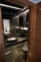 Shower, designer toiletries, hair dryer, towels