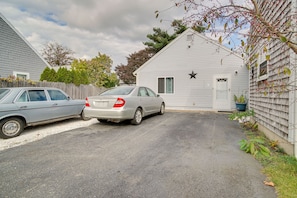 Drive up to a charming home with a star-shaped window and a driveway.