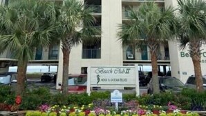 A multi-story hotel with balconies, palm trees, and a sign for Beach Club II. - 3BR 3BA Oceanfront 7th Floor N. Myrtle Beach Condo (North Myrtle Beach)
