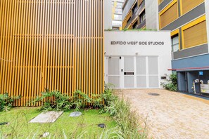 A building with a sign reading "EDIFICIO WEST SIDE STUDIOS". - Charlie Harmonia Vila Madalena (São Paulo)