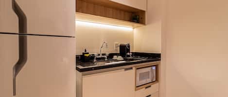 A modern kitchen with a built-in refrigerator, a microwave, and a sink.