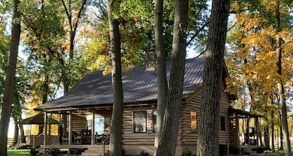 Modern Log Cabin in woods with two gas fireplaces; 20 acres; great location.