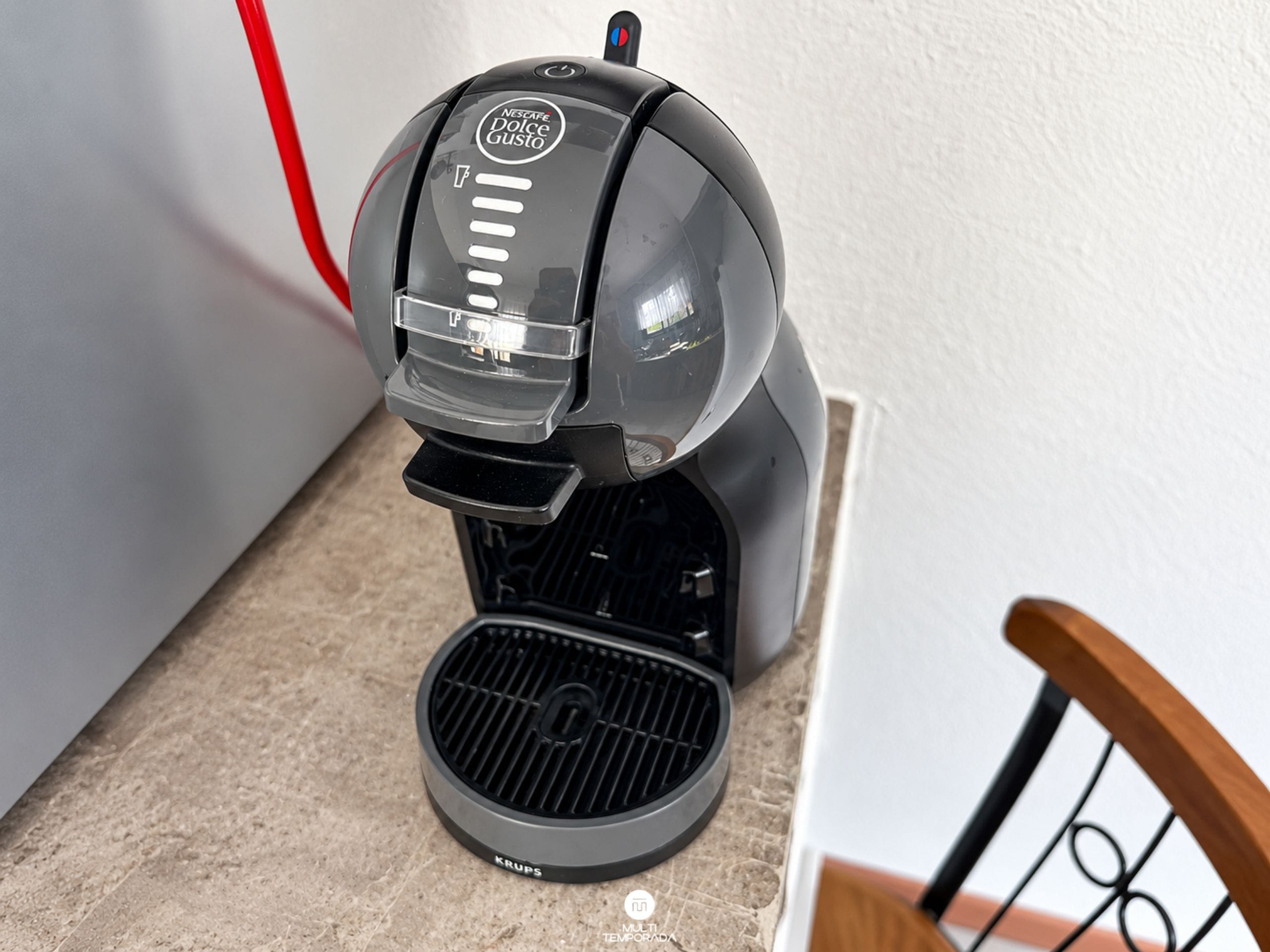 A Nescafe Dolce Gusto coffee machine on a kitchen counter.