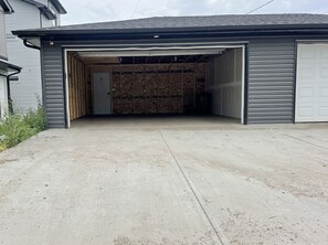 A garage with a concrete floor and a wooden door frame.