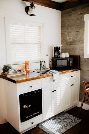 Fridge, microwave, coffee/tea maker, cookware/dishes/utensils