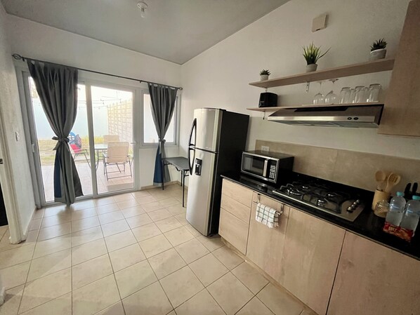 Fridge, microwave, stovetop, coffee/tea maker