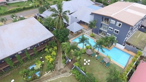 A hotel with multiple buildings, a swimming pool, and lush greenery. - Coconut Palms Resort & Diamond Casino (Port Vila)