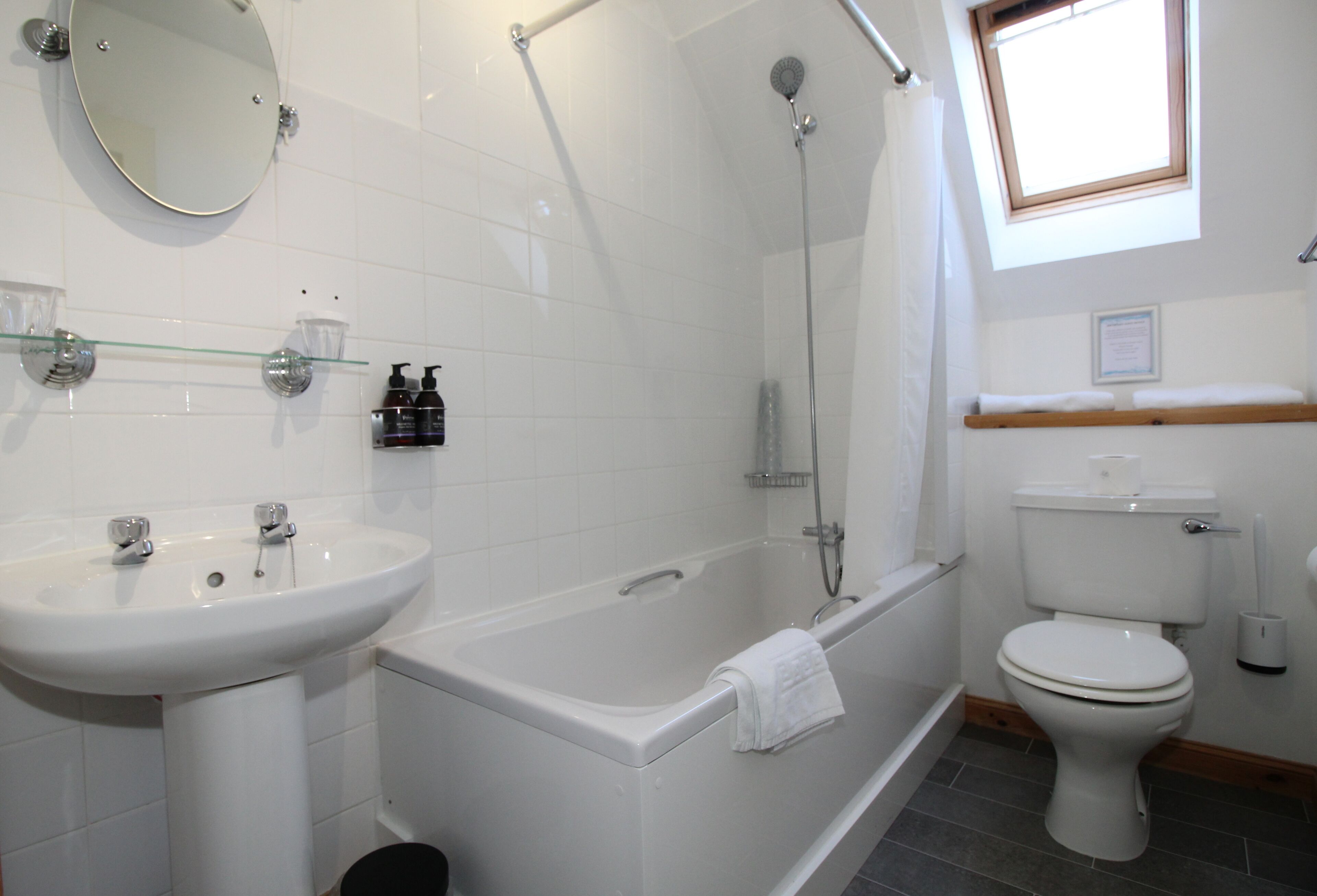 A modern bathroom with a bathtub, a toilet, and a sink.