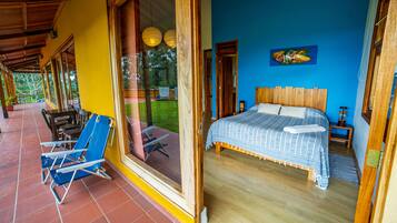 Un dormitorio con cama, ventana y vistas al exterior.