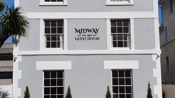 A two-story building with a sign reading "MIDWAY GUEST HOUSE EST. 1845". - Midway Guest House (Torquay)