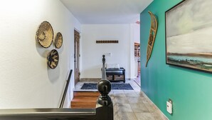 A hallway with a wooden staircase, a black bench, and a painting on the wall. - "Modern" Zephyr, 3 mins to beach, 7 mins to Heavenly, Casinos (Zephyr Cove)