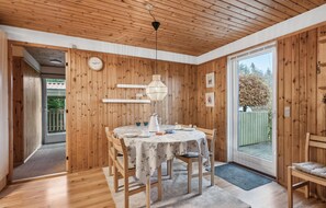 Enjoy meals in a warm and inviting dining area with a round table and comfortable seating.