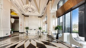 A spacious lobby with a marble floor, a reception desk, and seating areas. - JD POLMAN Hotel (Phnom Penh)