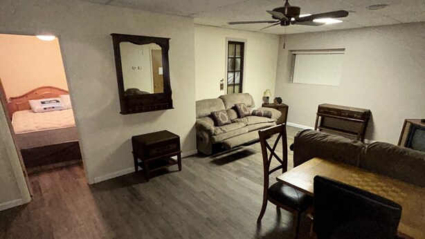 A compact living space with a sofa, a dining table, and a ceiling fan. - Spacious 2 Bedroom Apartment downtown Winifred,8 miles from the Missouri Breaks! (Winifred)