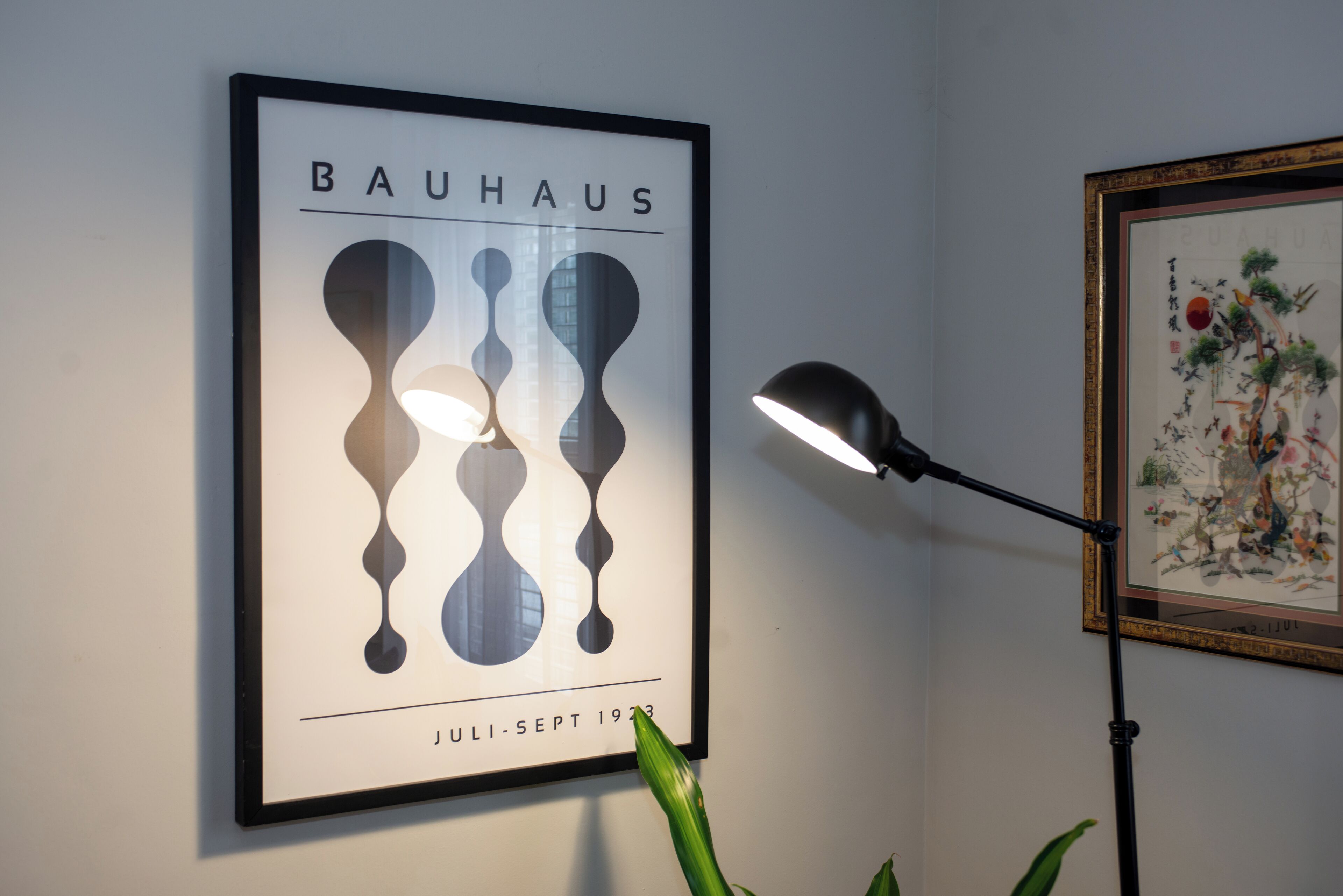A framed Bauhaus poster with abstract shapes and the text "BAUHAUS JULI-SEPT 1933" on a wall.