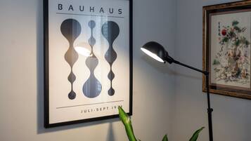 A framed Bauhaus poster with abstract shapes and the text "BAUHAUS JULI-SEPT 1933" on a wall.