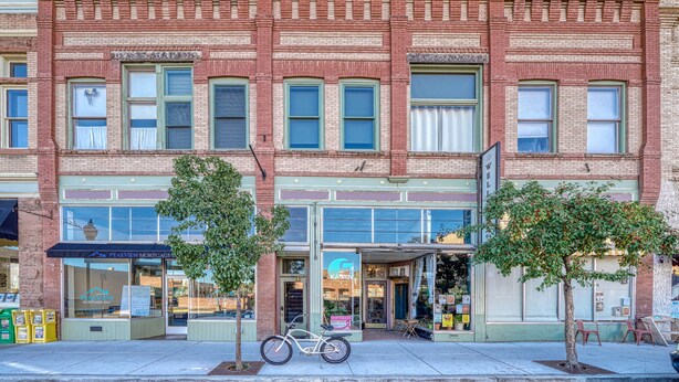 A two-story brick building with a storefront on the ground floor. - A Charming Loft in Downtown Salida! (Salida)