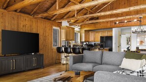 A spacious living room with a large flat-screen TV, a grey sectional sofa, and a wooden coffee table. - ~Fireworks On The 3rd~Sunrise Vista~Lakefront~Dock~Kayaks~Hot Tub~Games~NEW AC~ (Gaylord)