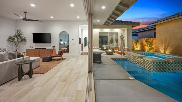 A modern living room with a flat-screen TV, a ceiling fan, and a fireplace. - Private pool & hot tub - PGA West retreat (La Quinta)