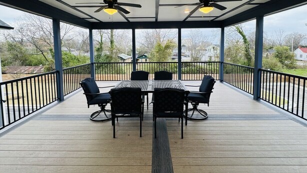An outdoor covered patio with a table and chairs, ceiling fans, and a view of the surrounding area. - Luxury Medical District Home, EV Charger, Gated #10 (Augusta)