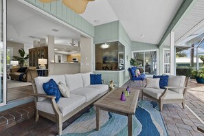 A spacious living area with a sofa, chairs, and a coffee table. - Luxury Canal Home | Pool, Spa & Dock Near Beach (Nokomis)