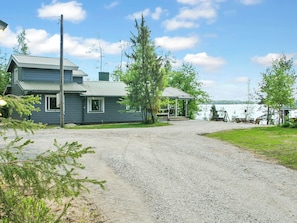A two-story house with a gravel driveway leading to a dock by a lake. - Ilotupa by Interhome (Pertunmaa)